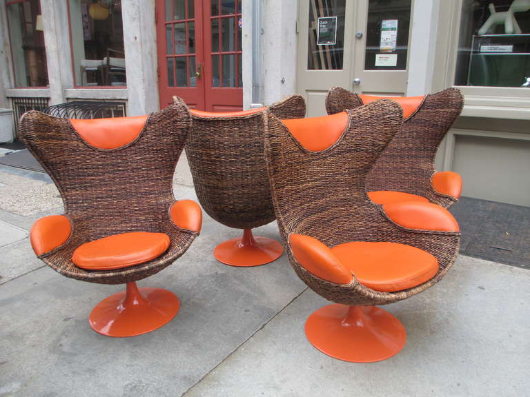 Brought back to the USA by a military family stationed in the Philippines during the 60/70's these four swiveling chairs are spot on replicas of the iconic Egg Chair.  The base is painted rolled steel and the upholstered cushions, arm and head rests