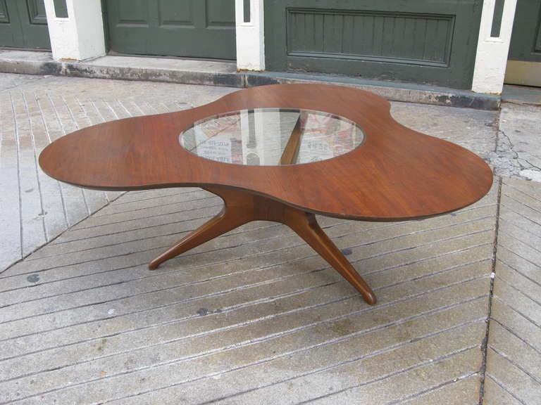 Free-Form Coffee table by Erno Fabry.  Beautiful Splayed Leg Design often seen on Kagan Furniture.  Solid Walnut legs with a clover-leaf top with center cut out for glass.  Probably refinshed in last 5 years.  Very nice condition.