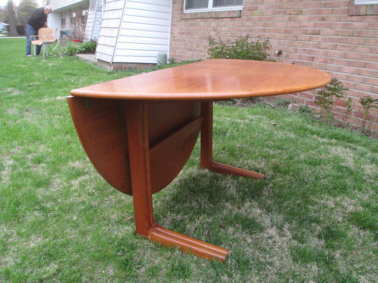 Unique drop leaf table which with just one drop leaf creates a half moon console table with gate legs.