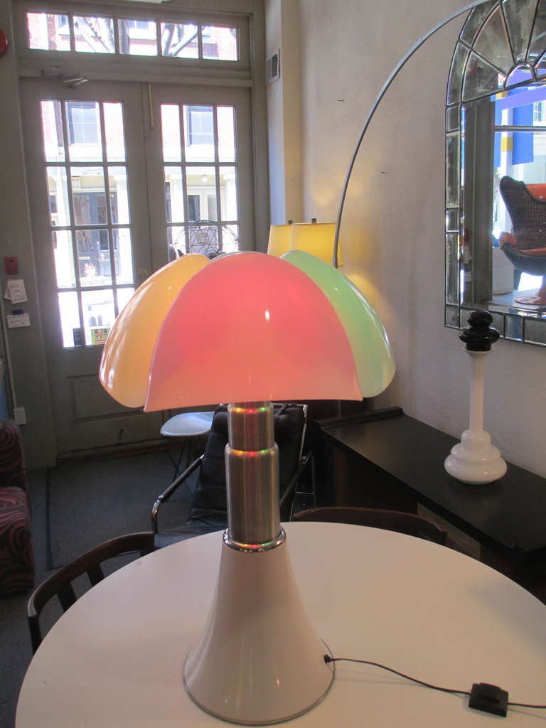 Gae Aulenti's Pipitrello (Bat) Lamp designed in 1966 and made by Martinelli Luce.  This lamp bought from the original owners who bought it from the Paris showroom have kept  the original colored light bulb scheme as it was displayed there. The base