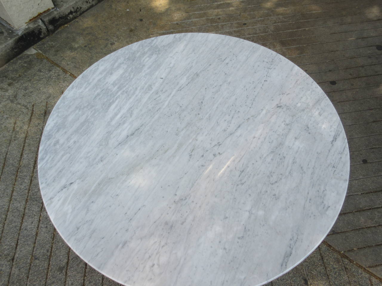 36 inch diameter marble Knoll dining table with cast aluminum base marked with label and Large cast K in base.