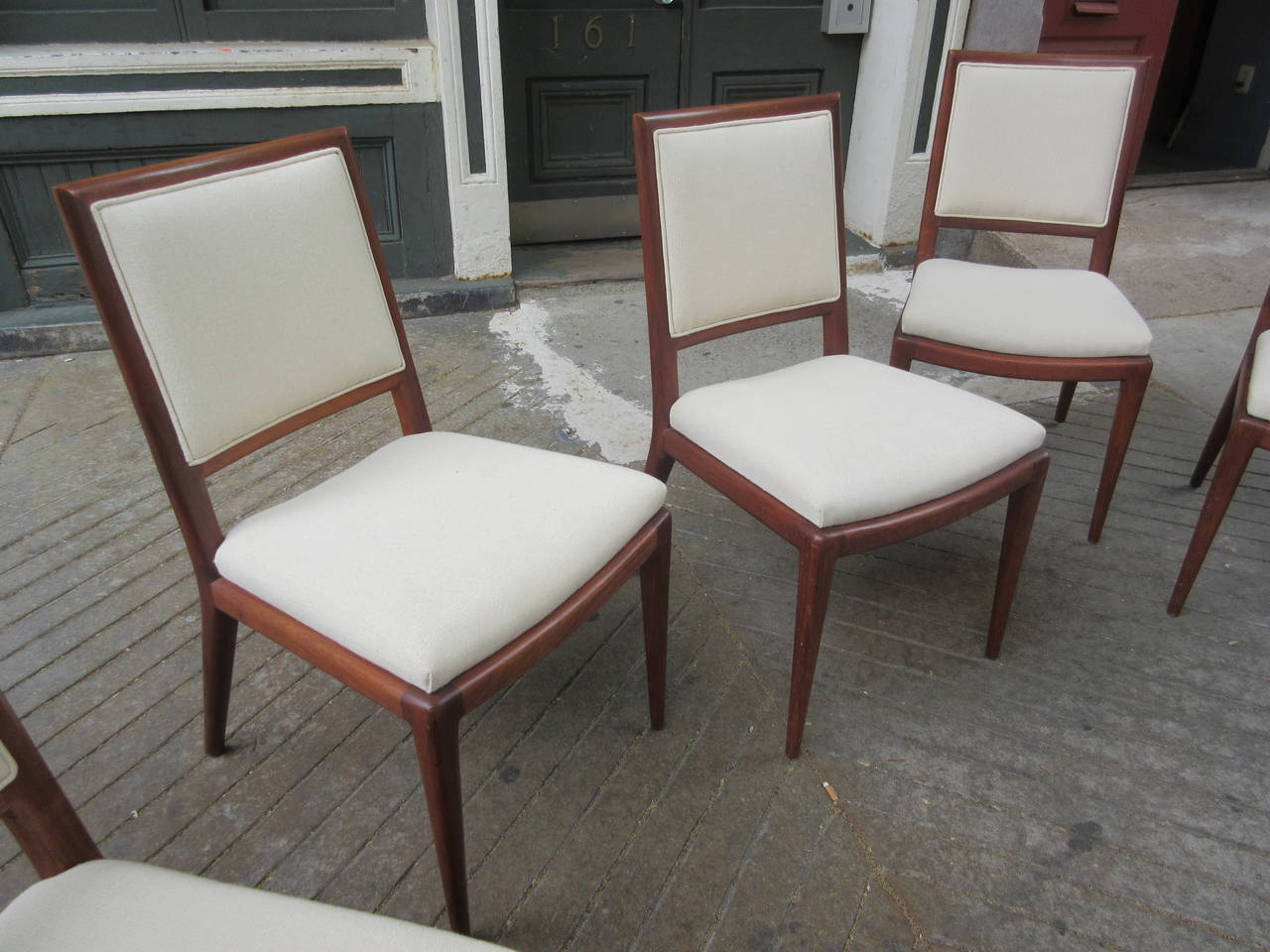 Solid walnut chairs with the accompanying Gio Ponti table shown in last photo. Both chairs and table bought from original owner in Princeton. Better pictures of table on its own page. Chairs have been recovered in a neutral off white fabric.