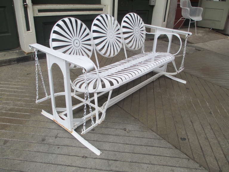 Unique 50's metal glider.  Can be detached from glider mechanism and used as a sofa.   Glide mechanism then folds flat for storage. Shape of seat provides a flexible seat and back of a daisy pattern.   