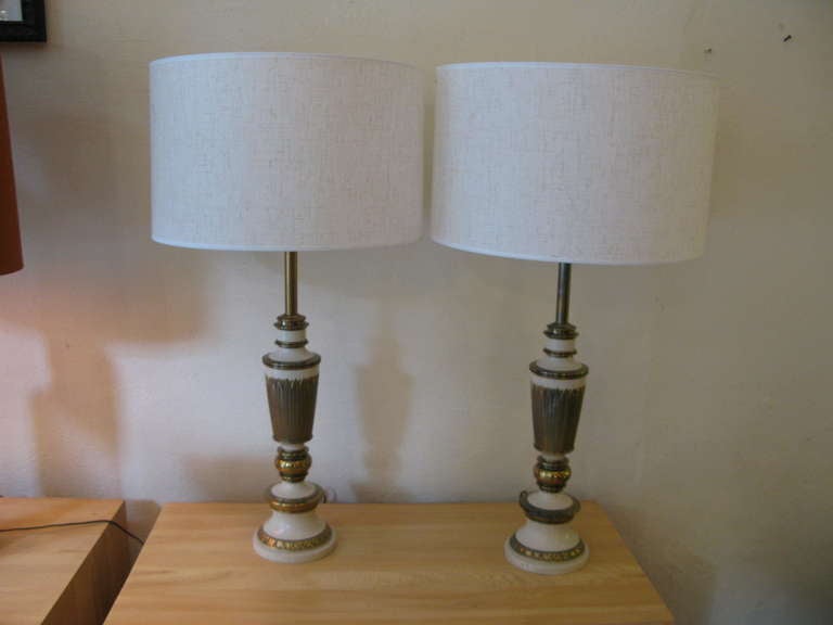Large Stiffel Lamps in Brass with an ivory paint applied.

Sockets of lamp retain Stiffel Paper labels.  