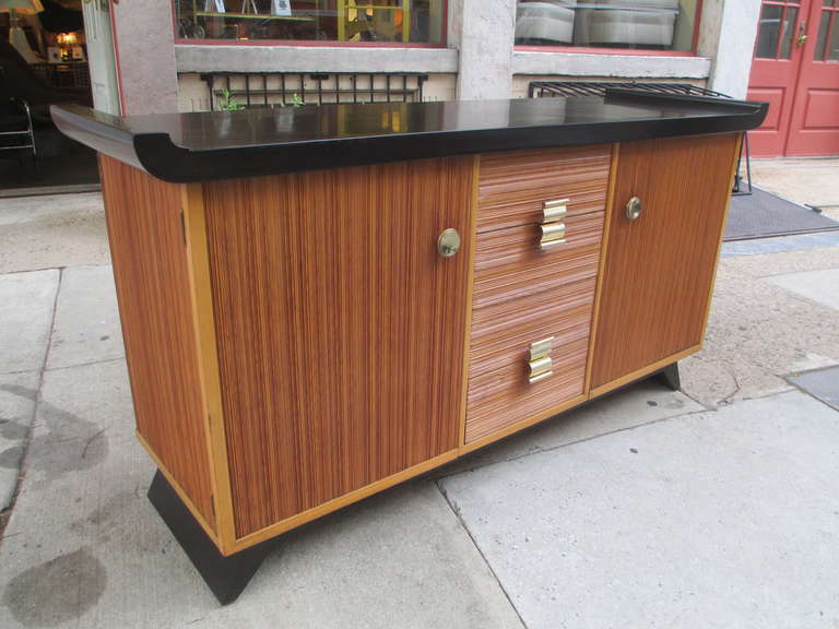 Elegant 1940's  Chinese influenced buffet by Paul Frankl.  Pulls are polished brass and the lacquer is a dark brown. With cerused oak body.