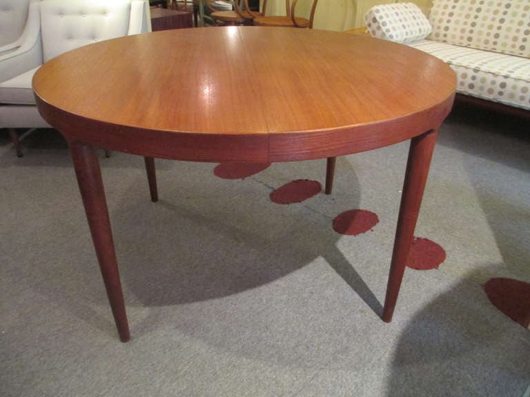 Round teak dining table with two leaves.  Pictures show closed, one and then two leaves.  We have priced separately  from matching chairs.  Seats 6 nicely with one leaf and 8 with two. Each leaf is 19.75 inches making the table 47.25 in diameter, 67