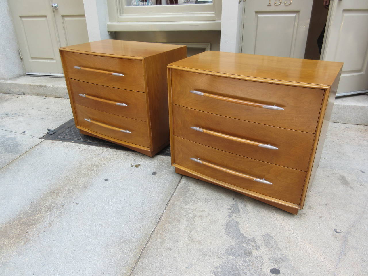 Two bowed front three-drawer chests of honey walnut and metal capped drawer pulls bought from original owners and part of a larger available set. Excellent original condition.