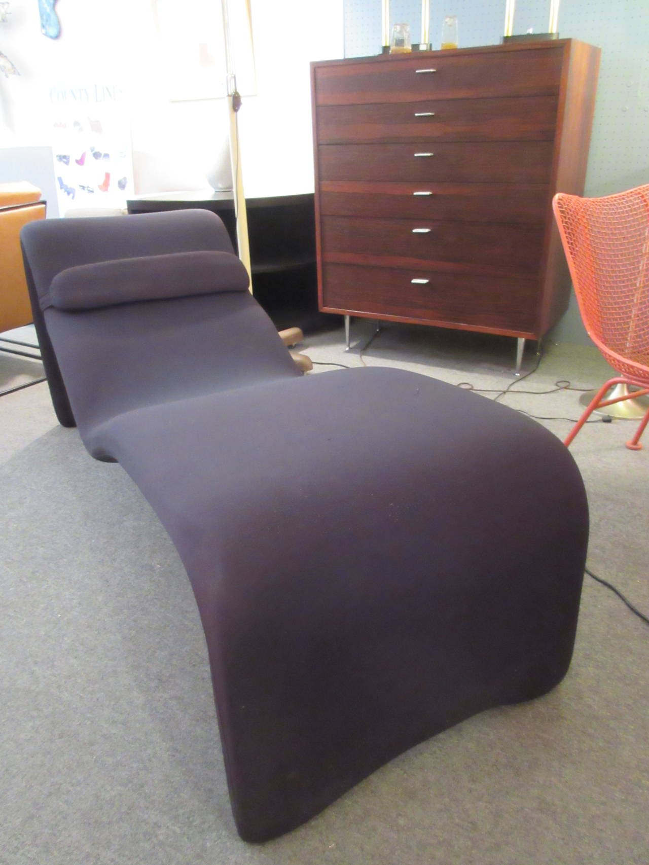 Futuristic chaise longue by Mourgue. Construction is foam suspended over a tubular metal frame covered in black stretch polyester fabric.