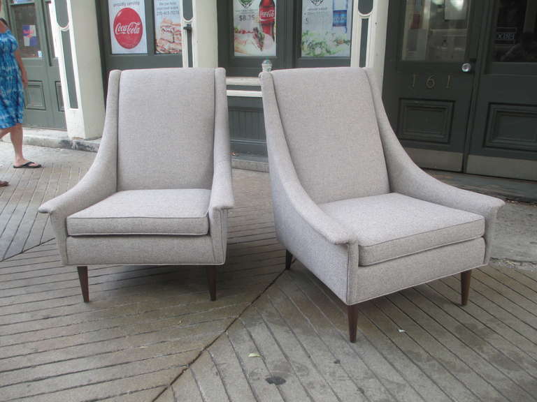 Newly re-upholstered Selig High Back Armchairs in a gray wool/ cotton blend.  Very comfortable, and great looking from all sides!  Chairs sit on walnut coned legs.