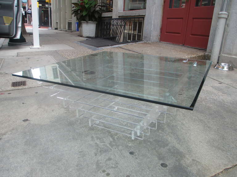 Square beveled glass top on base of stacked Lucite squares small to large