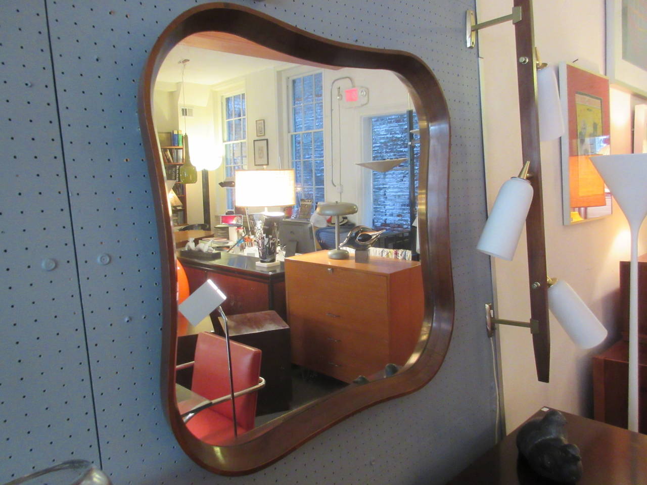 Large deep framed mirror of mahogany in a pinched square form by Herman Miller 1942. Was part of blue print series bedroom set of which we have a high and low chest, with king headboard, pair of nightstands and vanity dated 1942. Mirror has a deep