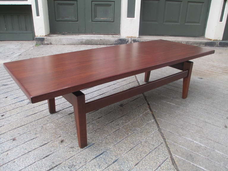 Jens Risom walnut coffee table from the Floating Top series from Rison's own company. Top appears to be detached and floating over legs.  Retains original label.