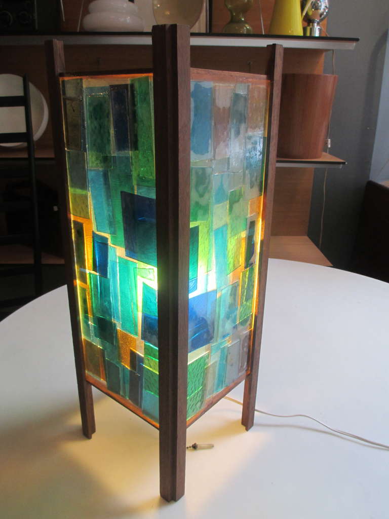 Signed Libby Pratt stained and fused glass lamp with teak frame.
