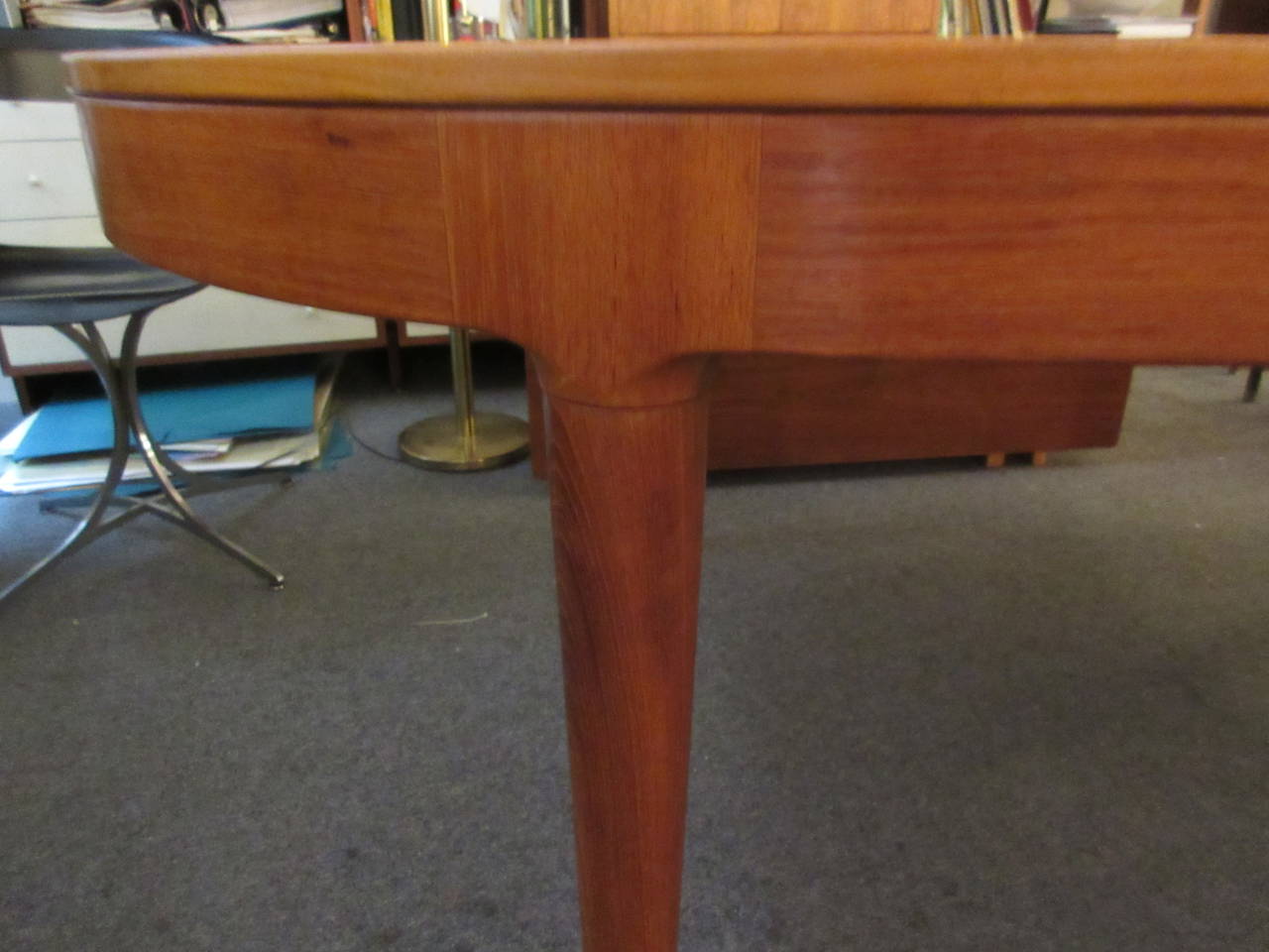 Table that can accommodate 12 with ease. Two Bi-fold 19.5 inch leaves are stored internally and can be put in place by one person. The two leaves extend the table to a length of 122 inches. Legs do not move to expand table. Legs are solid teak and