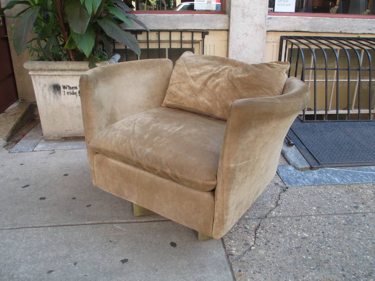 1970's suede barrel swivel chair in a dark khaki color sitting on a pivoting base with four square feet.  Unique split back design to 3 piece back.