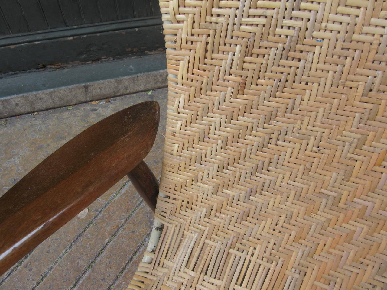 Graceful and delicate lounge chair with freshly re-caned sling seat with tubular metal frame. Chair's walnut collapses with keyhole connections while cane is ridged.