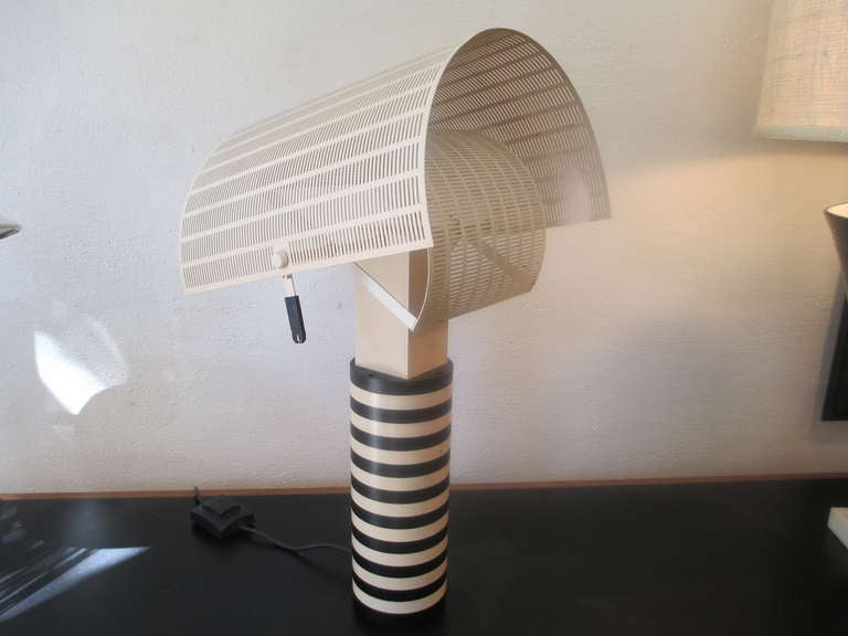 Memphis style lamp with two diffusers which pivot independently to shield the light source.  Artemide, Mario Botta, Shogun and made in Italy all molded into lamp base.