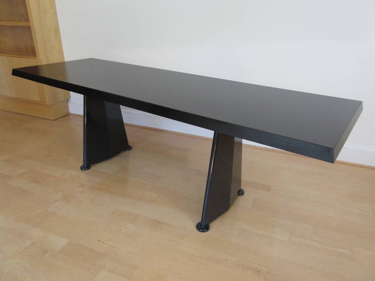 Prouve's table for the Cite Universitaire in Antony France 1954. Table is a series of trapezoidal shapes. The top is a black laminate and the base painted steel.  Retains metal Vitra label.