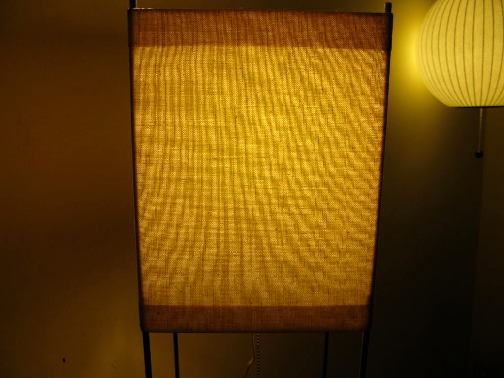 Simple burlap or canvas fabric streched around a chrome frame.  nice detail of round ball for pull switch.