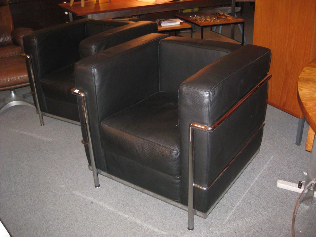 Pair of German version recent production (bought in 1999)of the Le Corbusier,, Pierre Jenneret and Charlotte Perriand Petit Comfort Leather arm chairs with heavily grained elephant hide black leather cushions and welded chrome plated steel frames