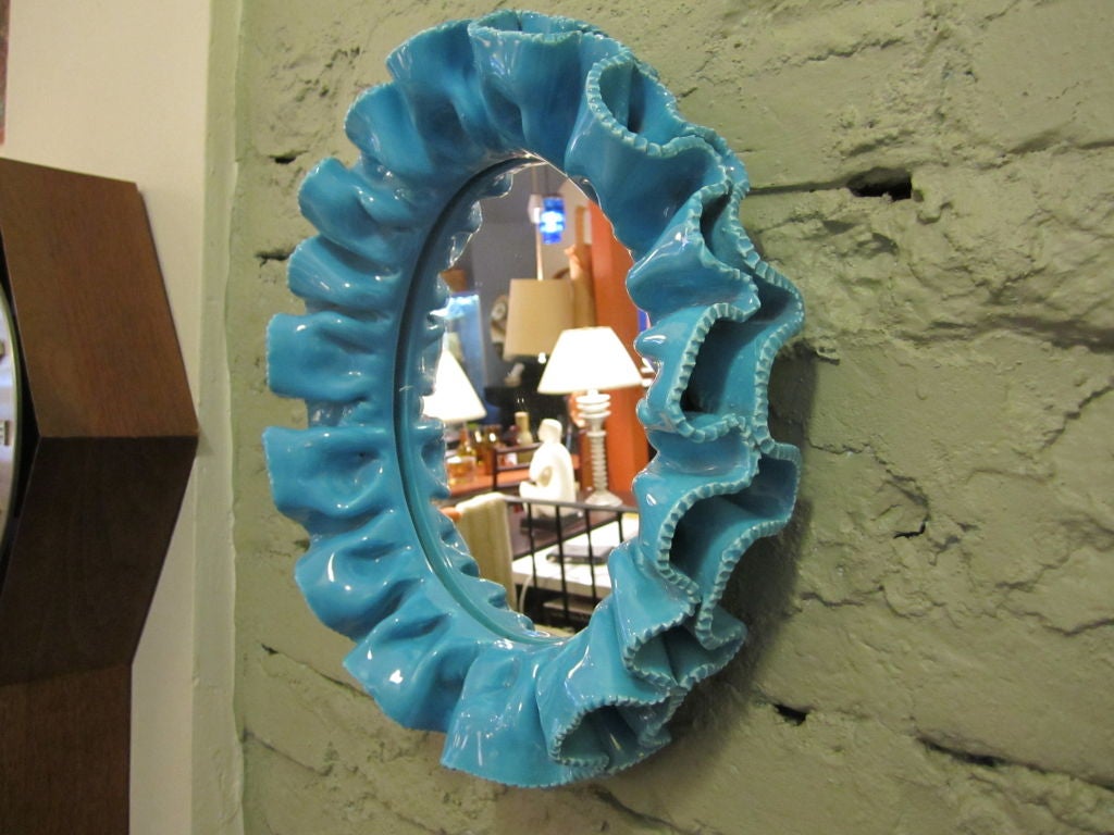 Turquoise glazed Oval mirror of ceramic folds to mimic folds of fabric.