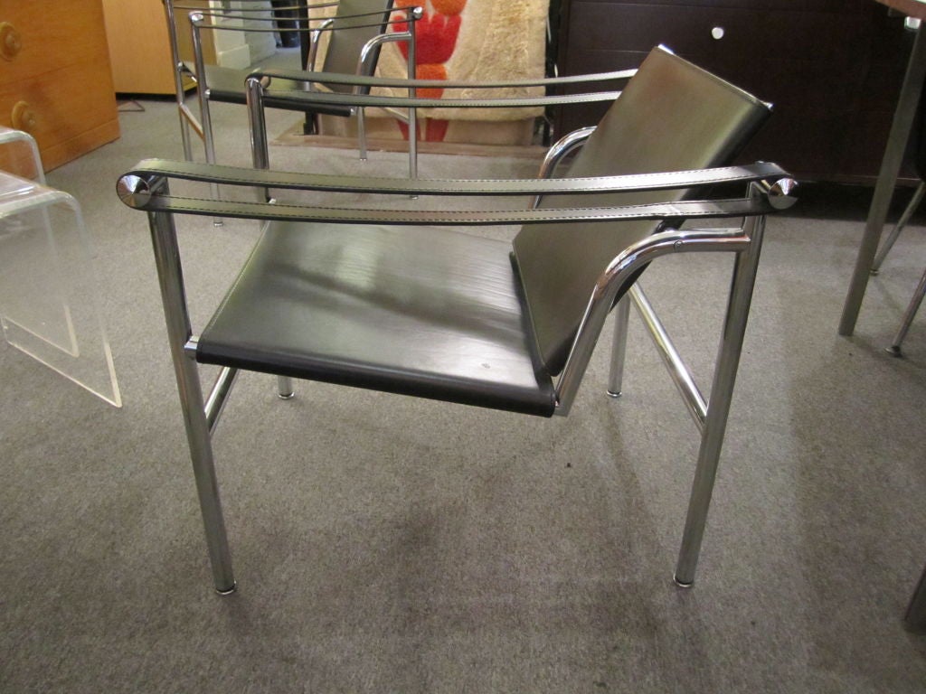 Pair of Basculant Model B301 by Cassina.  Chairs are 15 years old and in mint condition.  Back moves to provide maximum support.  All leather strapping is taunt. Cassina mark stamped in Chrome