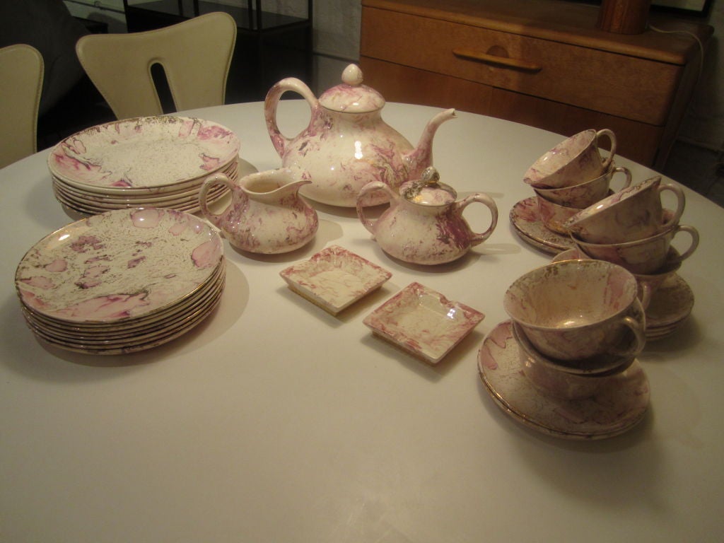 Luncheon set of service for 8 (10 inch plates, 8 inch plates,cups and saucers)  with 2 ashtrays, coffee pot, creamer and sugar in Brastoffs swirled gold,pink and gray design.  Each piece is marked