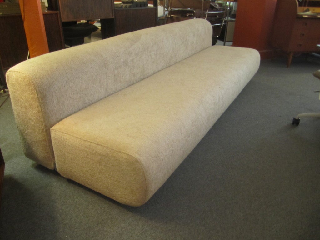 Fully upholstered sofa of two sections connected at base with chrome plated steel. This large size is no longer made
