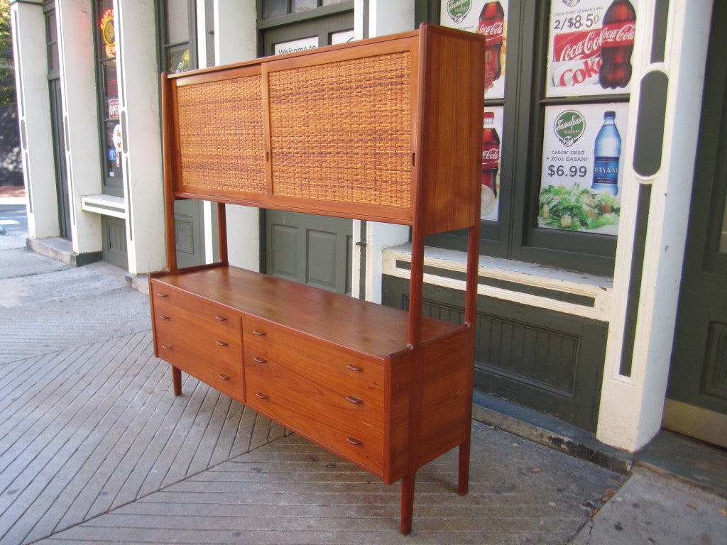 Six drawer cabinet with top of sliding raffata covered doors which reveal 5 adjustable shelves.  Bought from original owner and retains metal Illums Bolighus label.