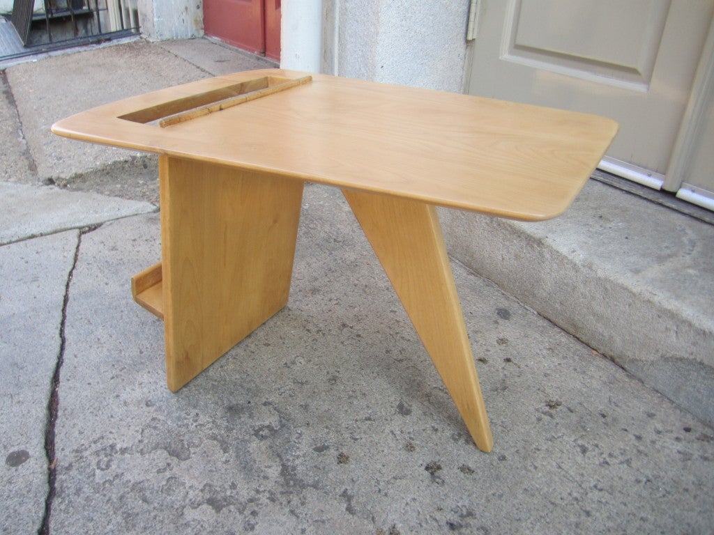 Animated solid birch magazine/side table with splayed leg and open top for inserting magazines.