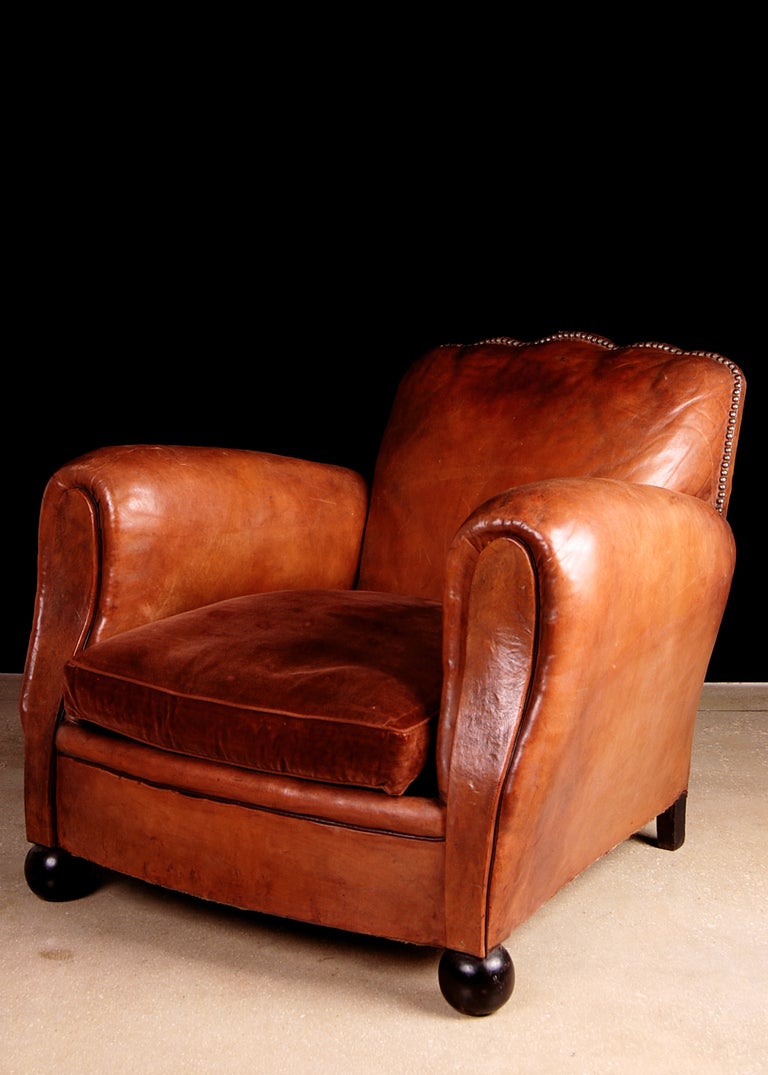 Pair of French Art Deco Period Scalloped Back Leather Club Chairs. Classic look, warm patina. Very generously sized. Seat cushion replaced with velvet.