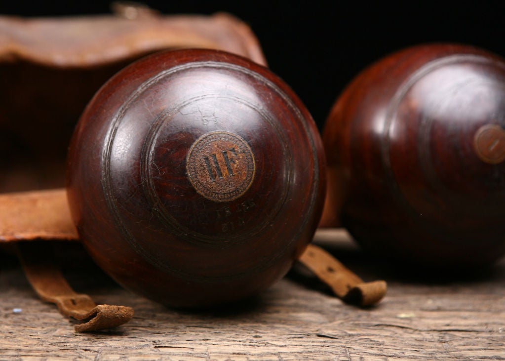 English Victorian Antique Lawn Bowling Balls Game Set in Leather Case. The game of Bowls (also known as Lawn Bowls or Lawn Bowling) is a precision sport popular in Victorian England and still played today, in which the goal is to roll 2 slightly