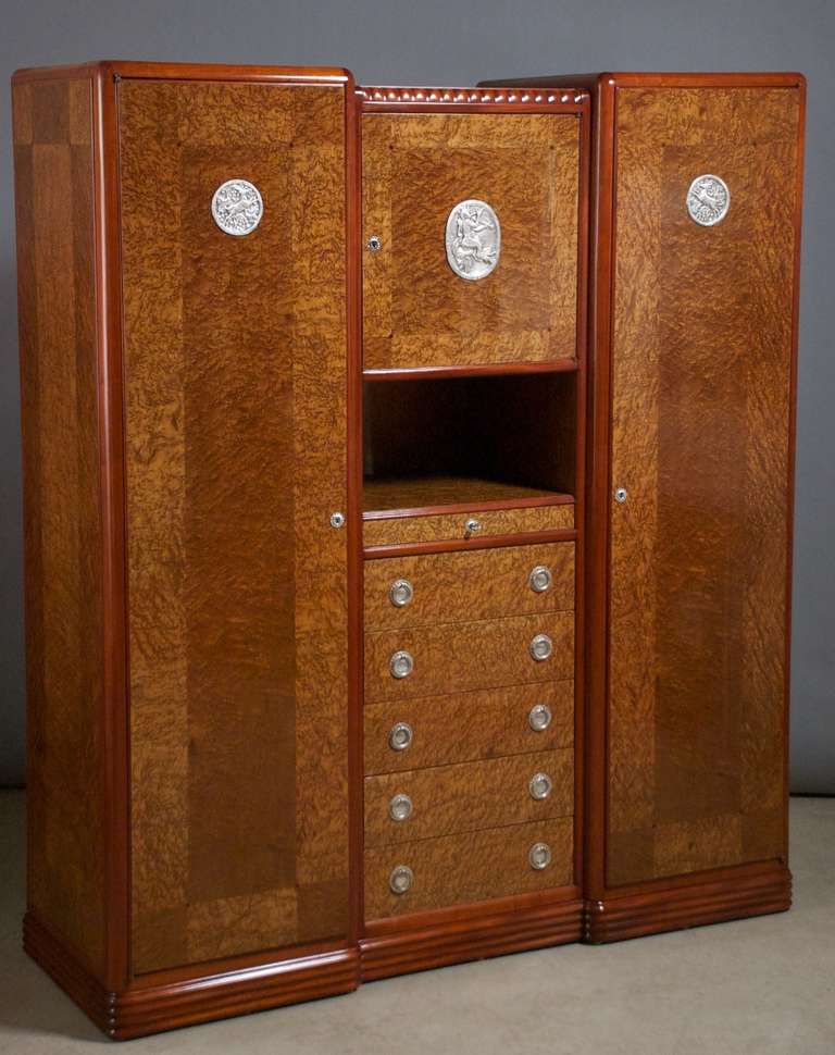 French walnut with silvered bronze sculpted plaques and pulls. Model presented at the Salon des Artistes Decorateurs, 1920. Pictured in period documentation.