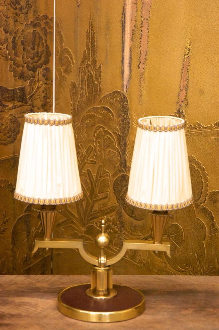 Pair of two-branch lamps, circa 1940, gilt bronze and original leather. Shades are re-covered original frames.