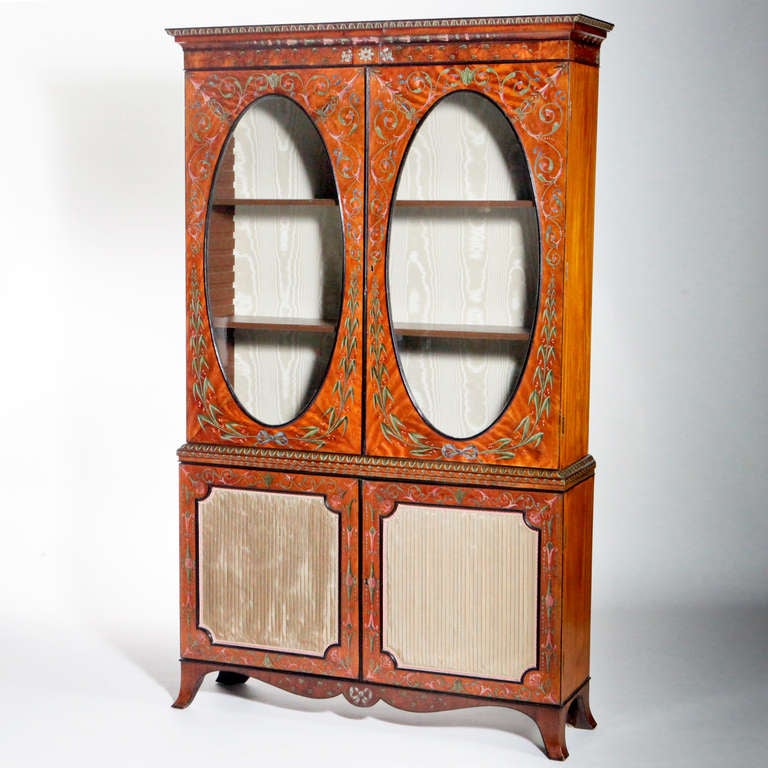 An exceptional late 18th century painted satinwood vitrine. Classic Adams style the hand-painted frame decorated with flowers, leaves and scrolls in pastel blue, green and pink tones. Features beautiful satinwood painted top cabinet doors with large
