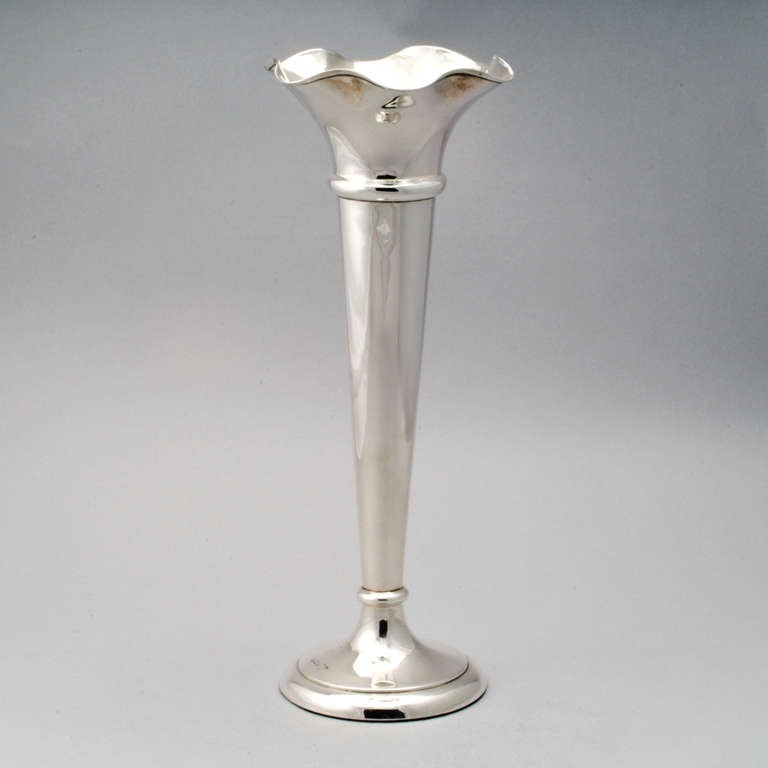 Large Edwardian trumpet-shaped sterling silver scalloped rimmed vase.  Hallmarked:  Sheffield, 1912.
Maker's mark:  Walker & Hall, a silversmith company active in England from 1896 until the 1960's.  This piece emulates the Edwardian style which