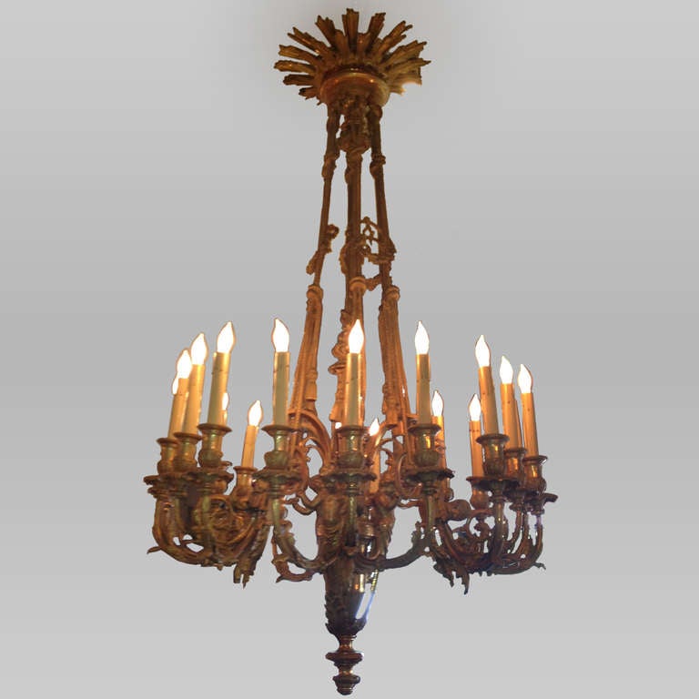 Ormolu cire perdue chandelier in tied rope pattern with tassels. Adorned with cherubs and acanthus leaves with sunburst design at cap. Cire perdue, also known as lost wax casting, is the French term for a method of casting in which a mold is formed