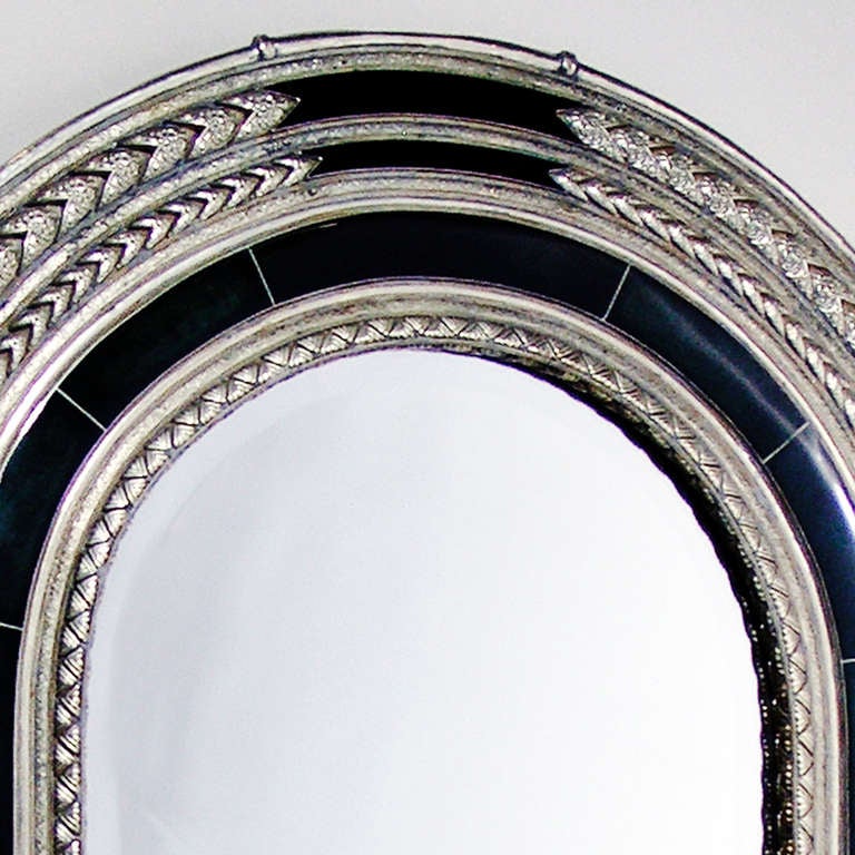 Large Berber tribe domed silver mirror with beveled glass and concentric braid pattern inlaid with dark green stone.