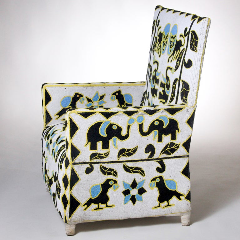 Exquisitely crafted Nigerian chair in black, turquoise and yellow colors on white background.  Canvas covered wood frame chair  with extensive hand beading.  African artists used native animals (elephants, lions and birds) juxtaposed with plant