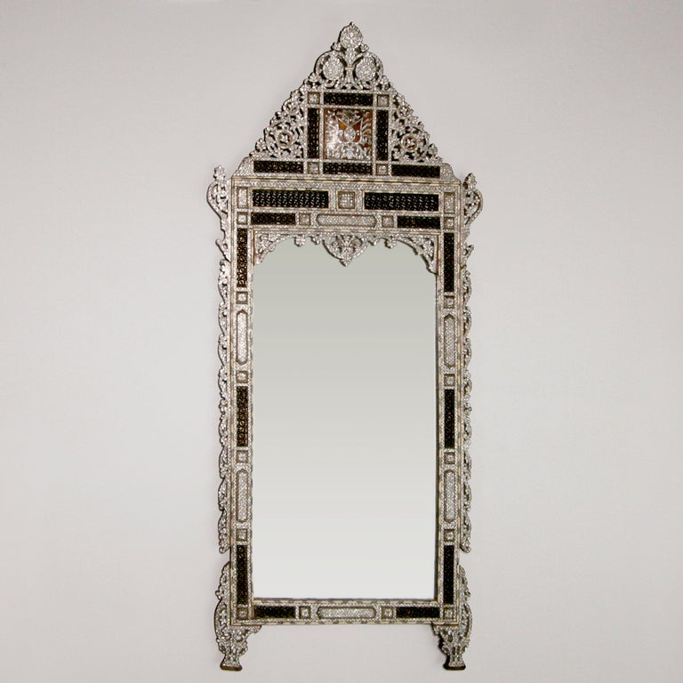 Large ornate Syrian mother-of-pearl mirror with high bonnet top.