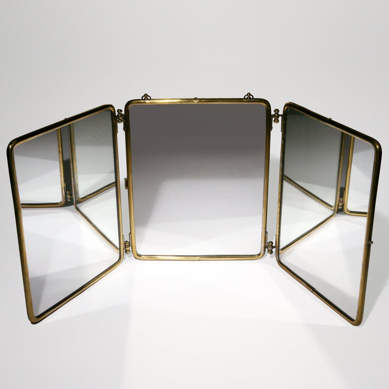 Rare antique three-panel folding mirror completely covered in shagreen.  Framed and hinged in brass with matching closure clasp for ease in travel.  Unfolds in any configuration to stand freely on a vanity.  Or use original brass hooks to hang on
