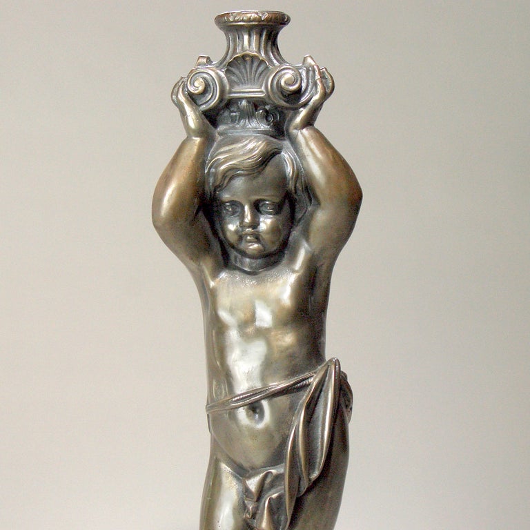 Decorative Victorian polished steel cherub figure. As it was once a pedestal bottom, round piece on top is hollow.