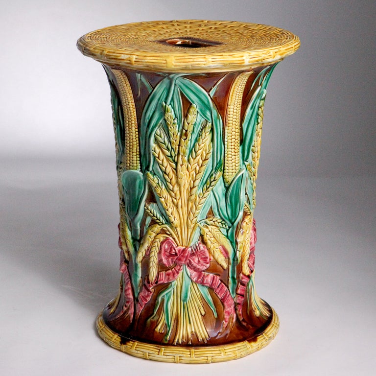 Corn pattern Majolica Adams & Co garden seat. Gold basket weave top and sheathes of wheat and stalks of corn tied with a fuchsia ribbon on a dark brown ground, circa 1880.