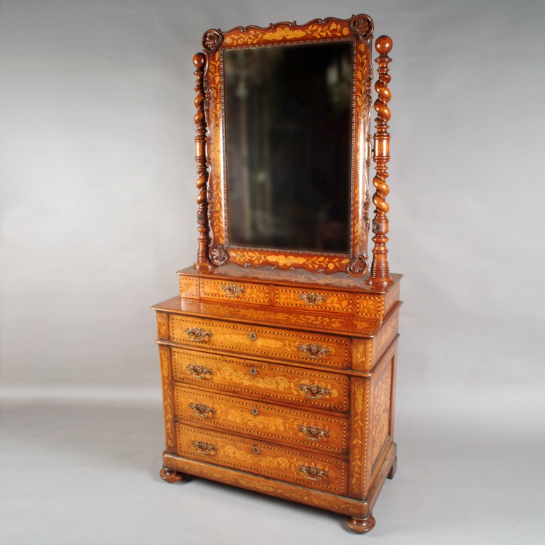 19th century Dutch marquetry dressing chest. Finely carved barley twist posts hold scalloped swing vanity mirror. Each post with original scrolled S-shaped brass candleholder. Mahogany chest in two pieces: the bottom with four large drawers the top