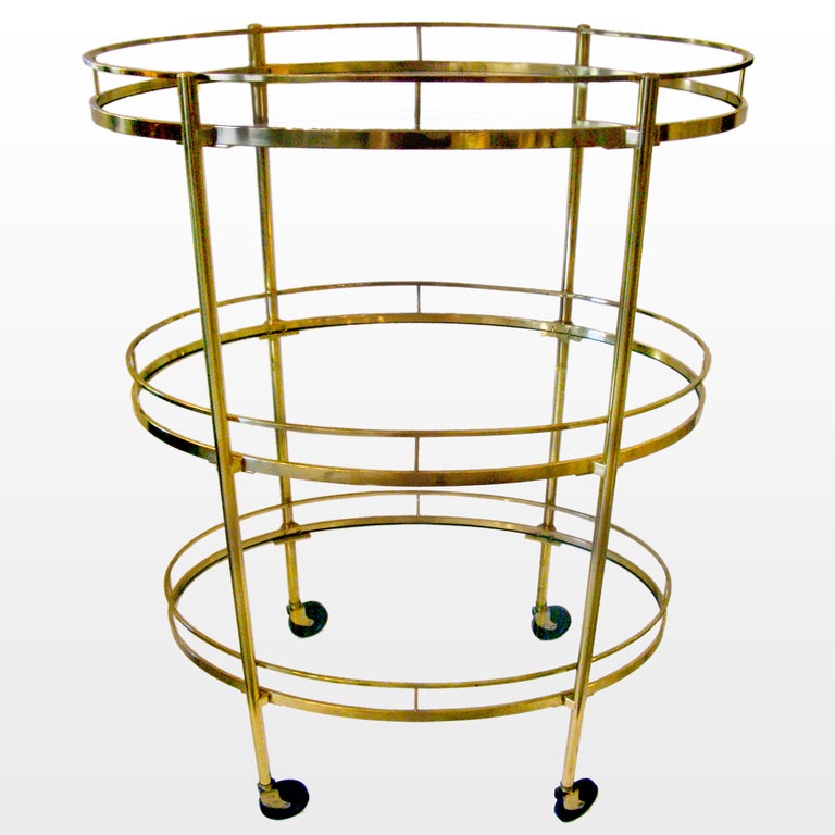 A vintage Maxwell Phillips brass bar/tea cart.  Hard-to-find in the three-tier style.  Original finish.  Glass shelves and casters.  Stamped and engraved:  M-P, Maxwell-Phillip Co Inc., New York.