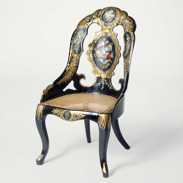 Important English Victorian black lacquer papier mâché chair. Scalloped back with open-work intricately inlaid with mother-of-pearl in floral motifs. Caned seat and period cabriole legs.