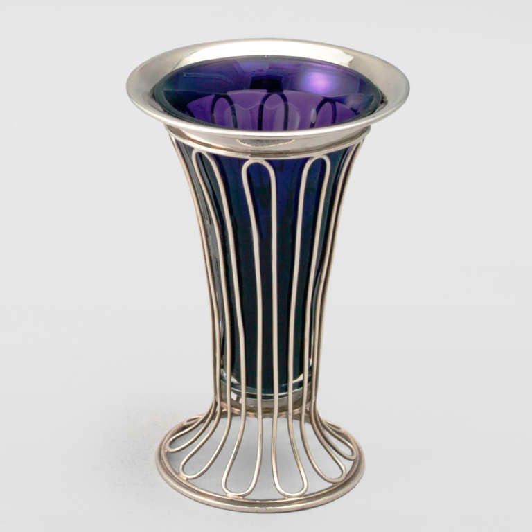 Silver vase with unique arched wire design and rare purple glass liner. Hallmarked: Birmingham, 1907.