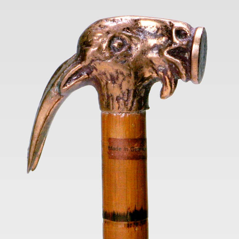 Unique antique bronze Shoemaker's cane with hammer handle. The hammer, in the shape of a goat's head, detaches from the body of the hard wood cane for use. Inscribed 