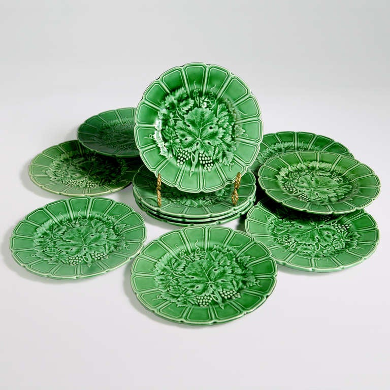 French green majolica plates with scalloped edge and a large leaf  pattern with grapevines, grape leaves, and clusters of grapes.  Set of 12 plates.  Impressed:  Sarreguemines, France