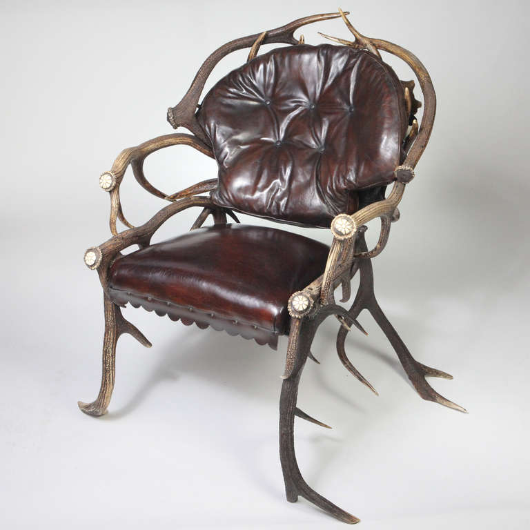 Rare late 19th century Bavarian deer antler armchair. Designed with large fallow deer antler-shaped backs under natural red deer antlers. Expertly crafted with interlocking antlers, the side arms designed with two tiers of long antlers. The seat and